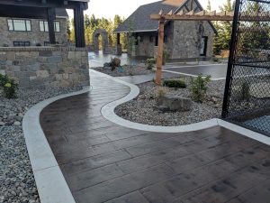 Stamped concrete sidewalk with white concrete